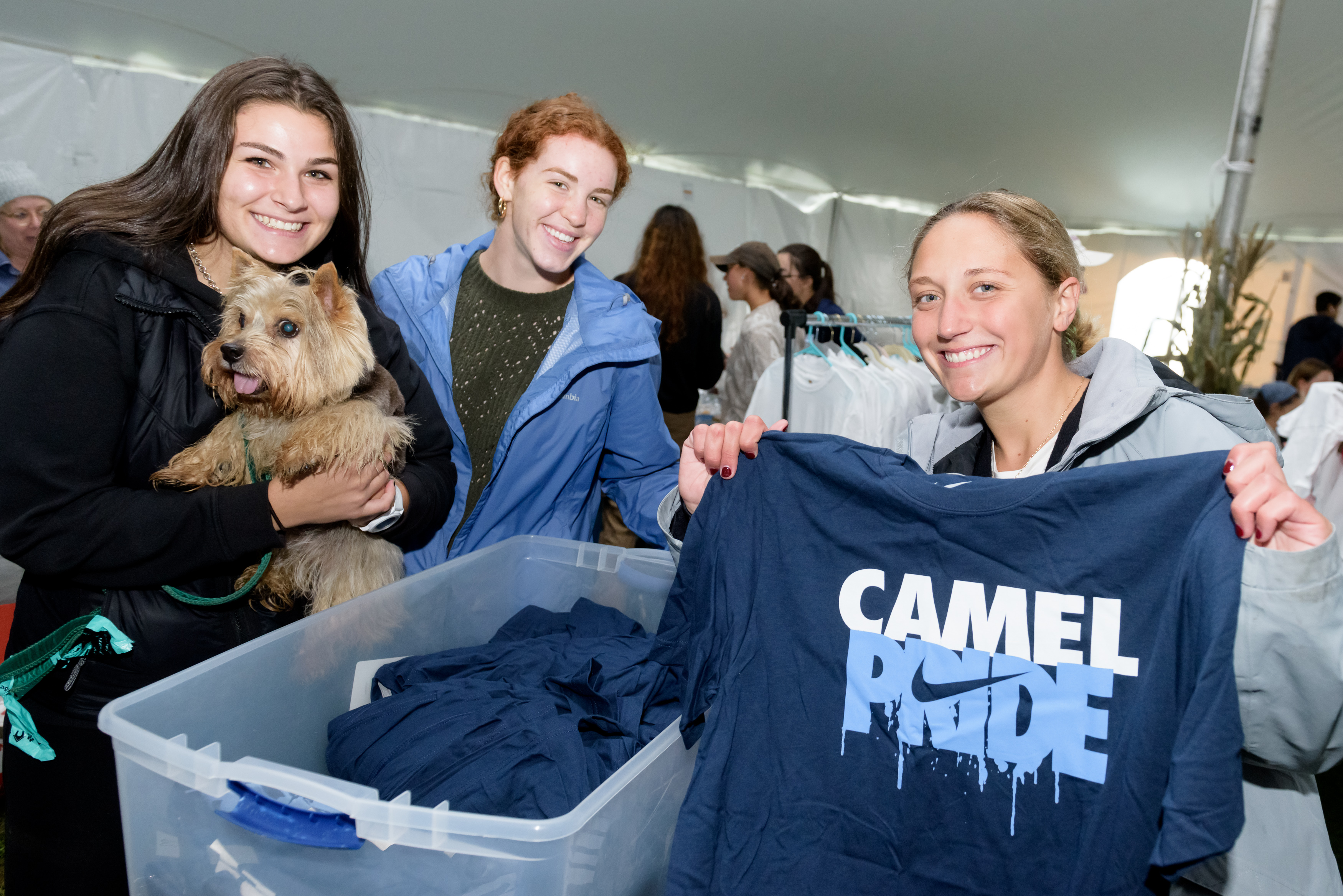 Students posing with camel merch