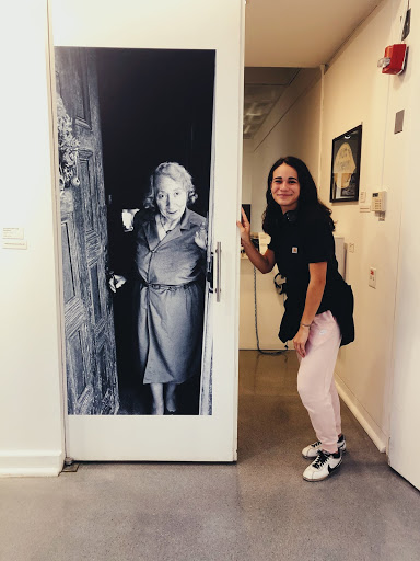 Student Dani Maney poses with a life-sized photograph of the Nut Museum founder