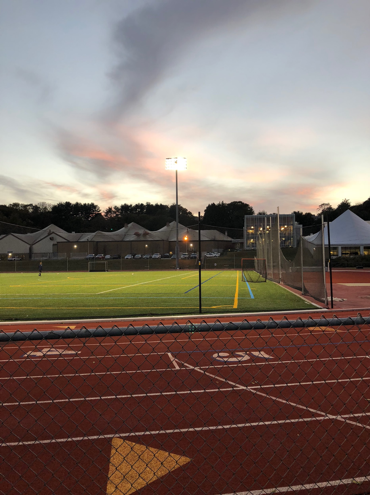A photo of the Connecticut College track at sunset