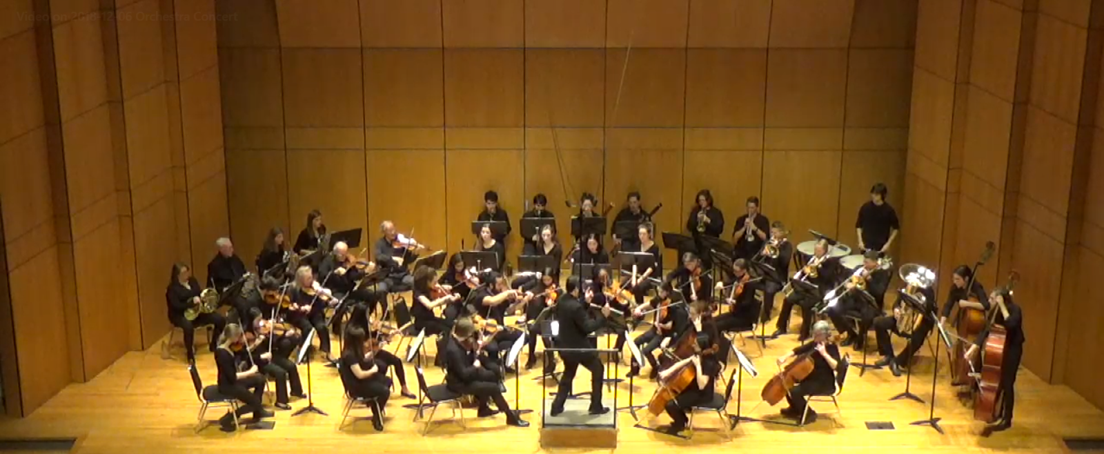 A view of the orchestra playing on stage at Conn.
