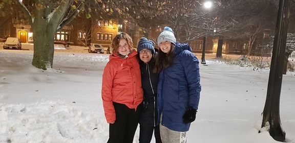 Samirah and her two friends pose for a photo together outside in the snow