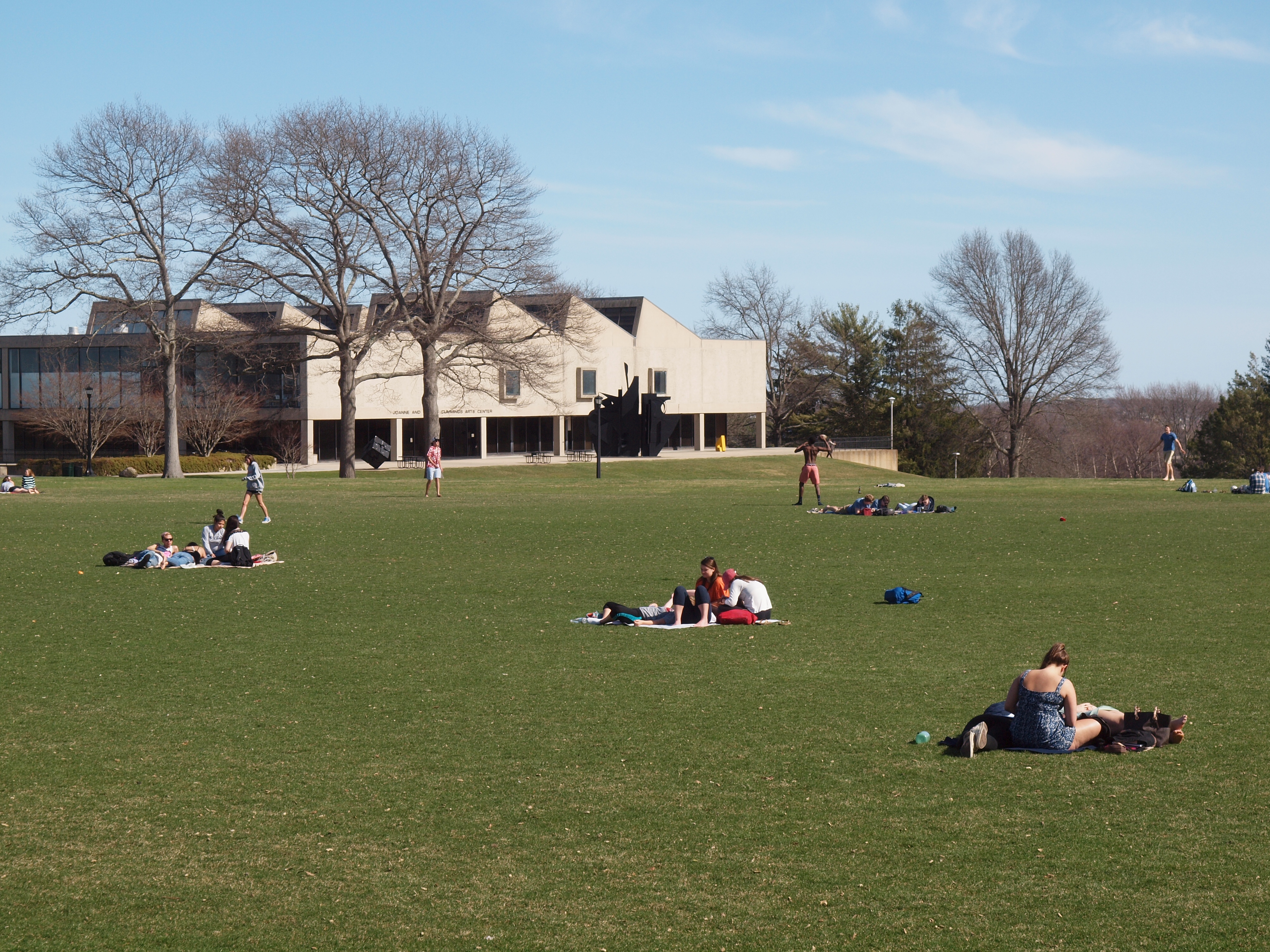 Students relax on a field 