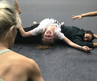 Dance department students smile for the camera during a moment of rest in the studio.
