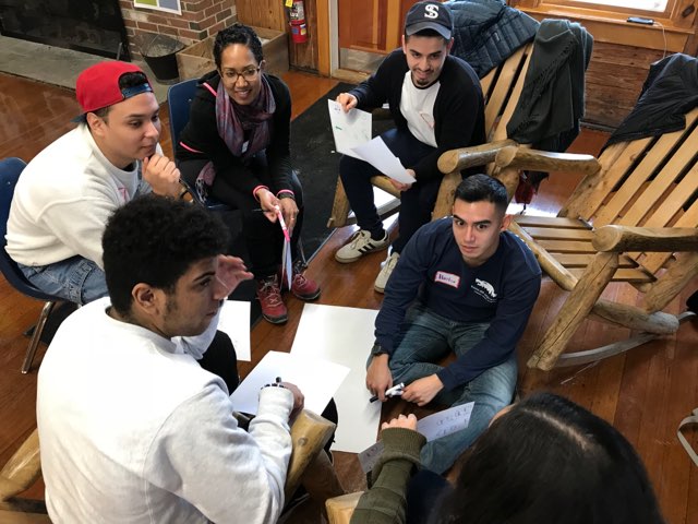 Students sitting around a table working together
