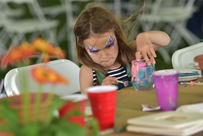 A young artist puts the finishing touches on a project at Paint Party with Cindy Price Stevens '79 on Saturday afternoon