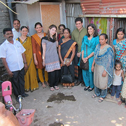Professor Sunil Bhatia (center right, in green) visits Pune, India, as part of his work with Friends of Shelter Associates, a nonprofit he founded that has funded 600 toilets and sanitation projects in some of India's poorest regions.