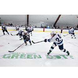 Taking a stand: Marc Roper '15 clears the puck during the men's hockey team's first Green Dot game in 2012. The event, which raises awareness for the sexual assault-prevention training program, has since become an annual tradition. Homepage: Real examples of '