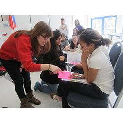 Sophomores Dana Sorkin, Lizz Ocampo, and Kaitlin Cunningham teach Russian to New London middle-schoolers at last year's International Student Expo, which was supported by the Mellon Initiative on Foreign Languages.