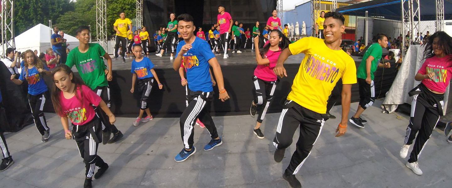 At-risk youth in El Salvador participate in a dance performance in a public park.