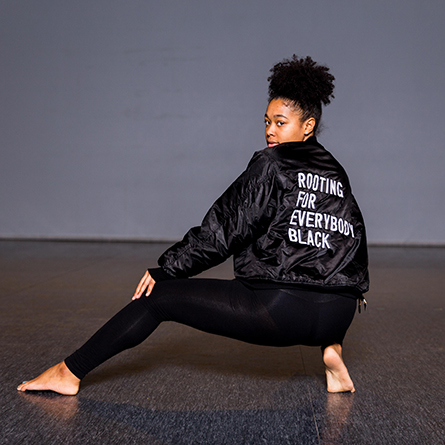 Tanaya Cadenales ’18 wears a statement jacket for her performance in “We Are Here,” a step piece by Jenaya Amore ’19.