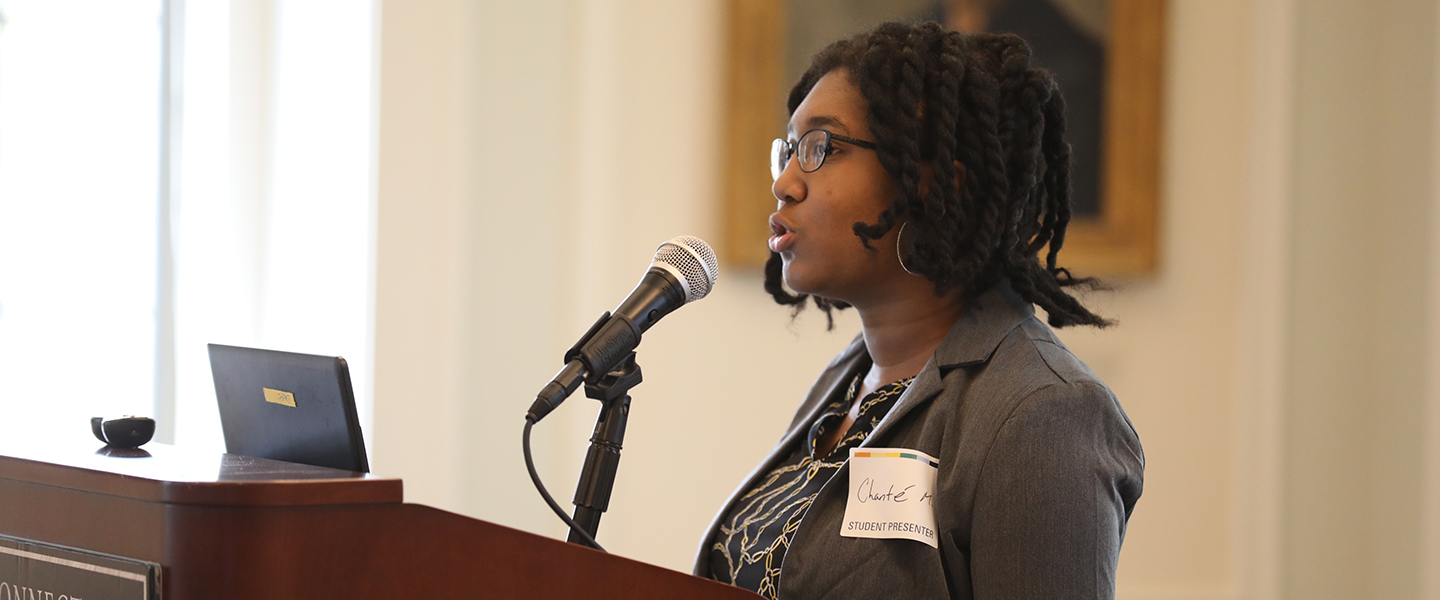 A student presents at the All-College Symposium