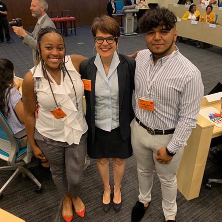 Alyss Humphrey ’22 (left) and Daniel Varela ’22 (Right) pose with President Katherine Bergeron at PossePlus Summit Town Hall in Westlake, Texas.