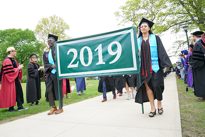 Members of the Class carry the 2019 banner