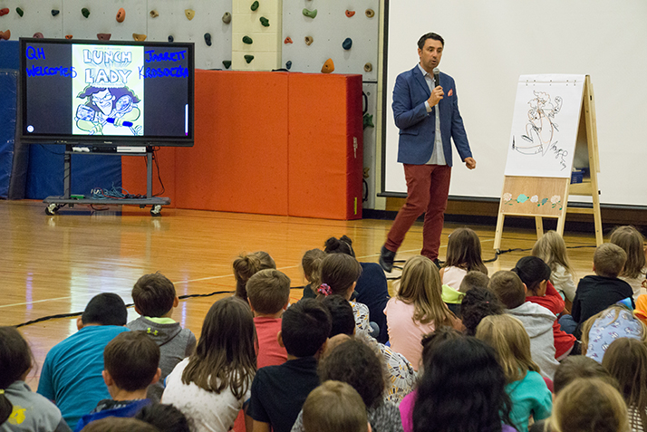 Author Jarrett Krosoczka presents to students at Quaker Hill Elementary School.