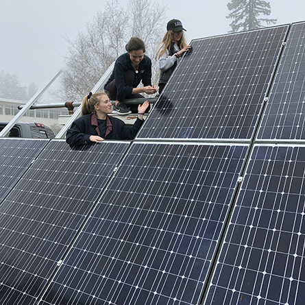 Students set up solar panels for an Earth Day celebration on campus.