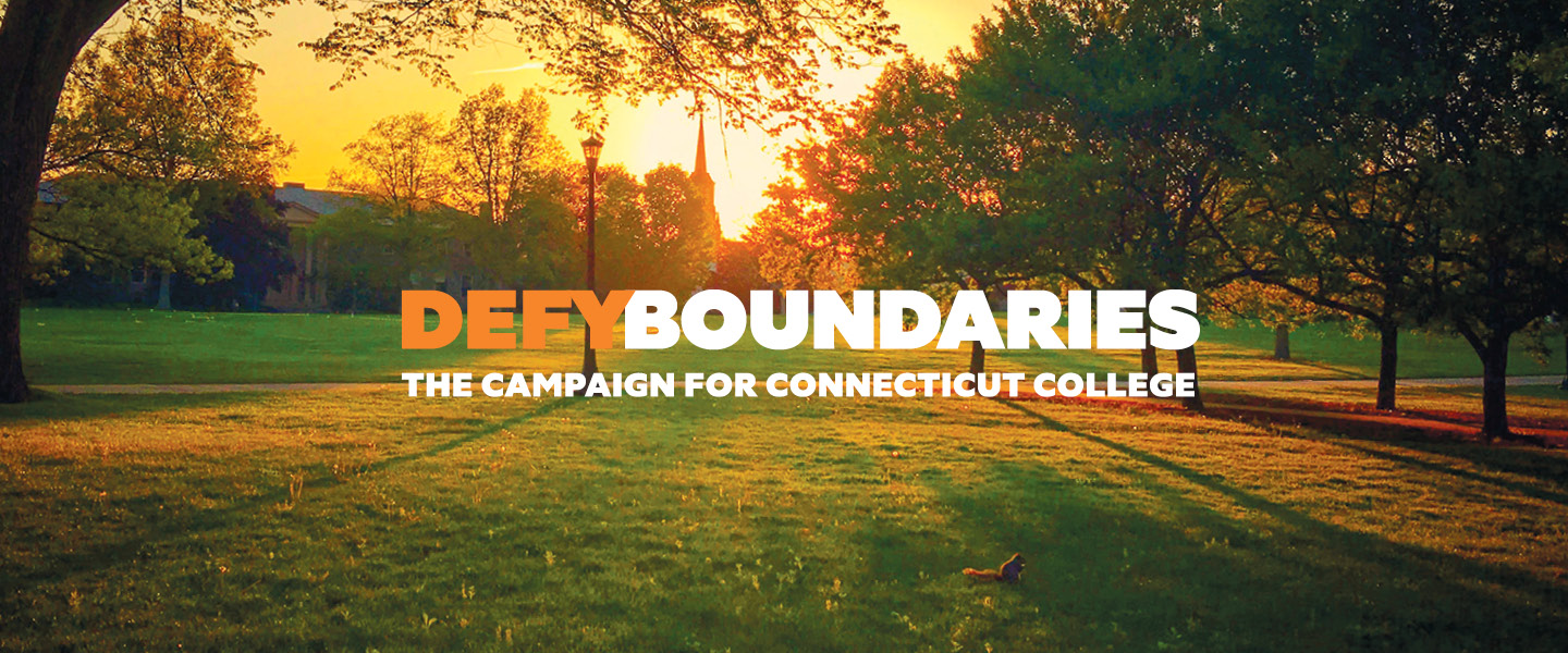 The Defy Boundaries logo on an image of campus in the fall.