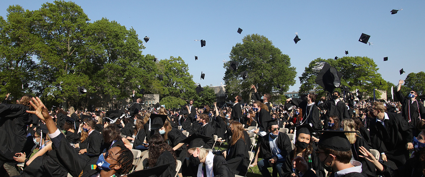 Graduates toss their caps