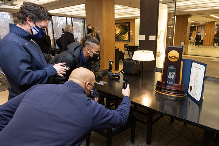 Players photograph the championship trophy with the Connecticut general assembly official citation presented to the team. 