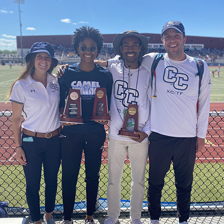 Malissa Lindsey ’23, second from left, and Jeffrey Love ’23, second from right, celebrate with two of their coaches and their NCAA Championship hardware at the DIII outdoor championships in Geneva, Ohio. 