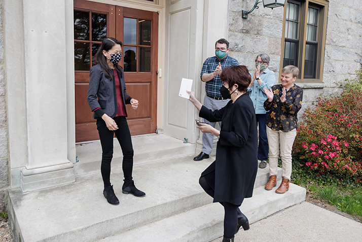 President Katherine Bergeron surprises Dot Wang with a staff award as her colleagues cheer.