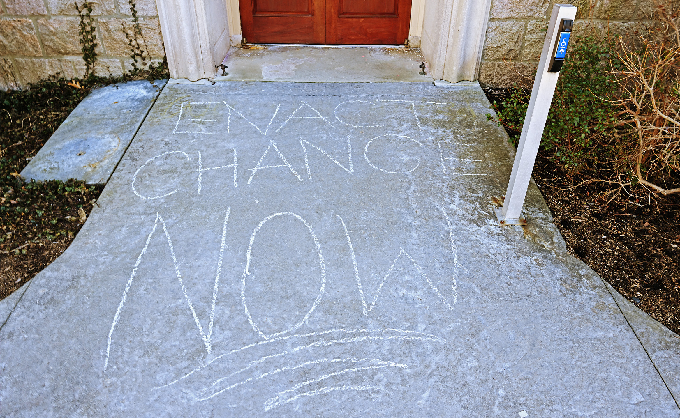Chalk protests on the sidewalk outside of Fanning Hall reflect recent concerns on campus raised by students, faculty and staff.