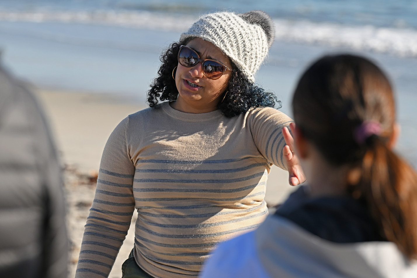 Professor of Biology Maria Rosa talks to her bio students on the beach