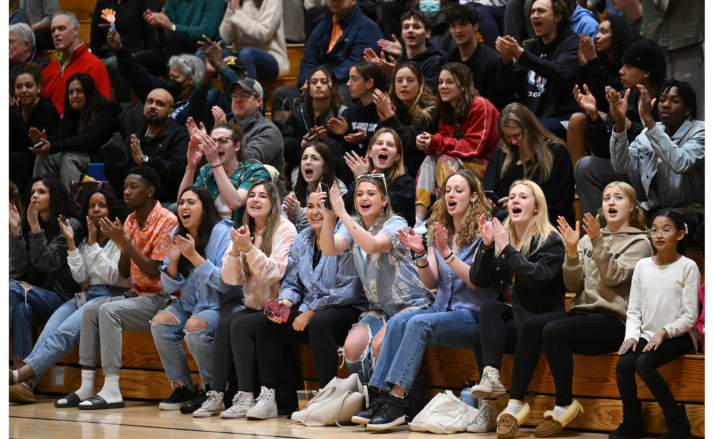 Fans cheer the Connecticut College men's basketball team against Williams College in NESCAC basketball action in Luce Field House.